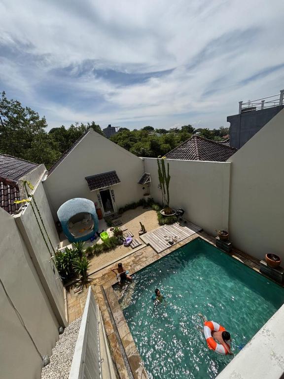 an overhead view of a swimming pool with two people in it at Gyuzel villa di lembang in Citeureup 1