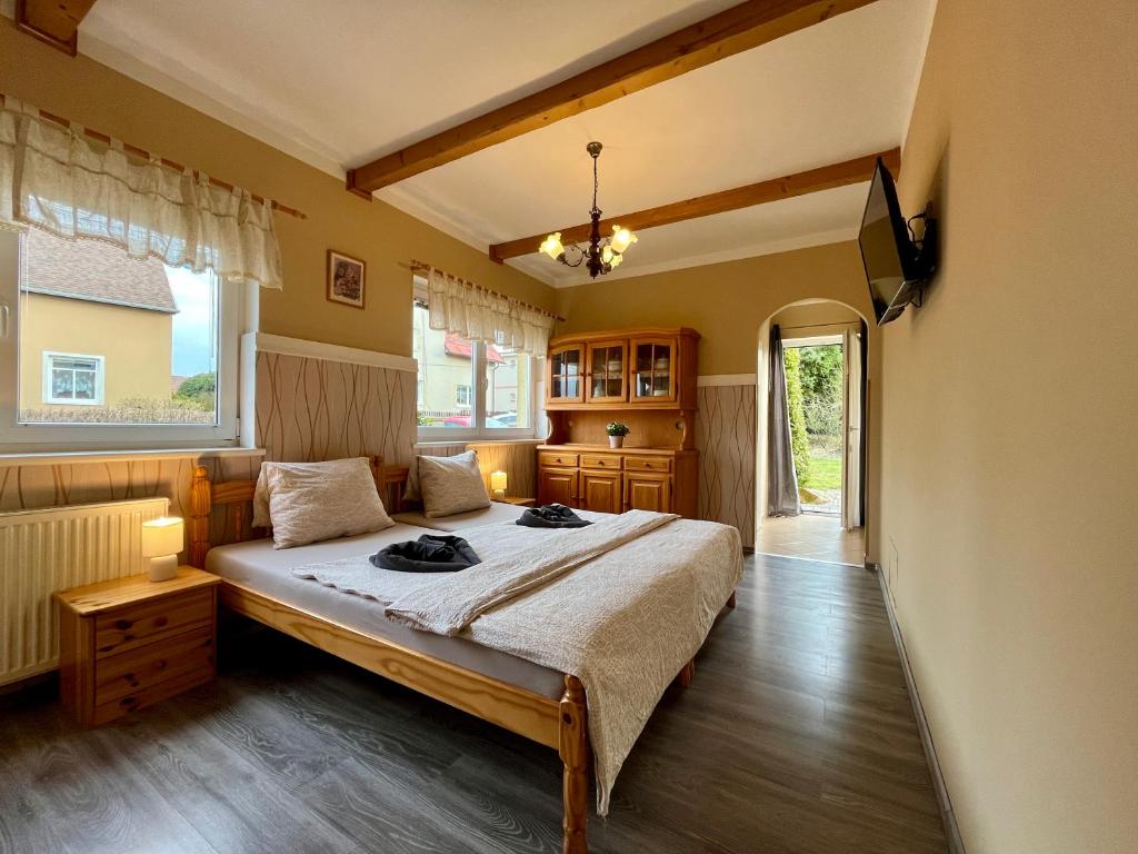 a bedroom with a bed and a tv in it at Penzion Žírovice in Františkovy Lázně