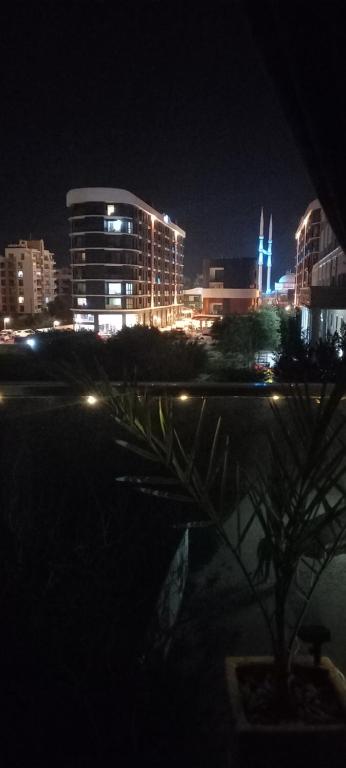 a city lit up at night with a building at Studio LUX in Famagusta