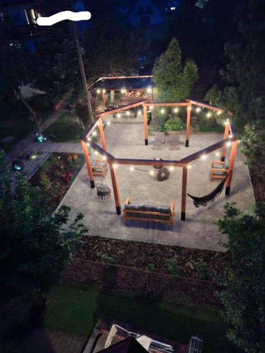 an overhead view of a park at night with benches at Na Brzysku in Jabłonka