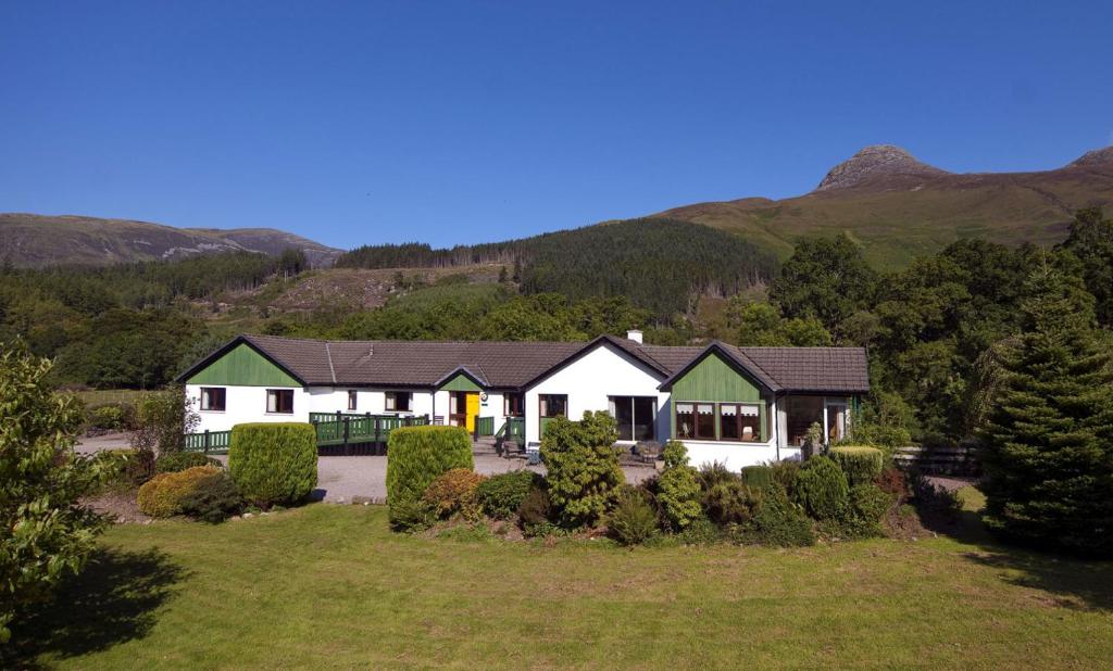 an aerial view of a house with mountains in the background at Cherry Tree Cottage in Glencoe