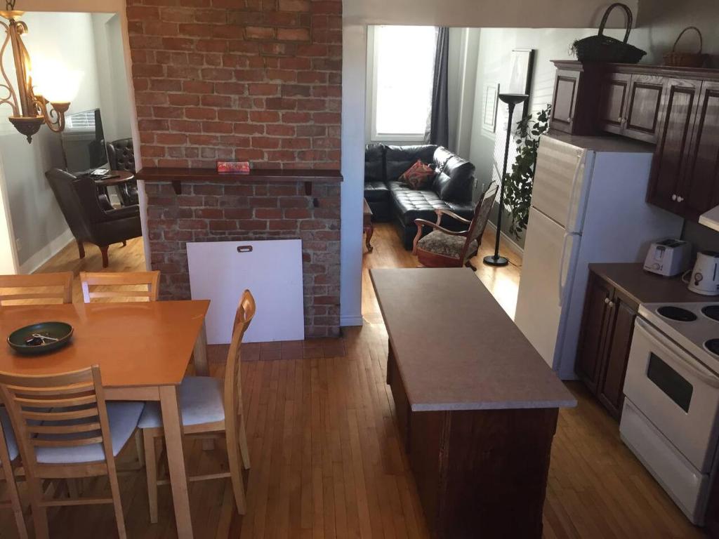 a kitchen and living room with a table and a dining room at Downtown Apt 5 Private Deck Queens Road in St. John's