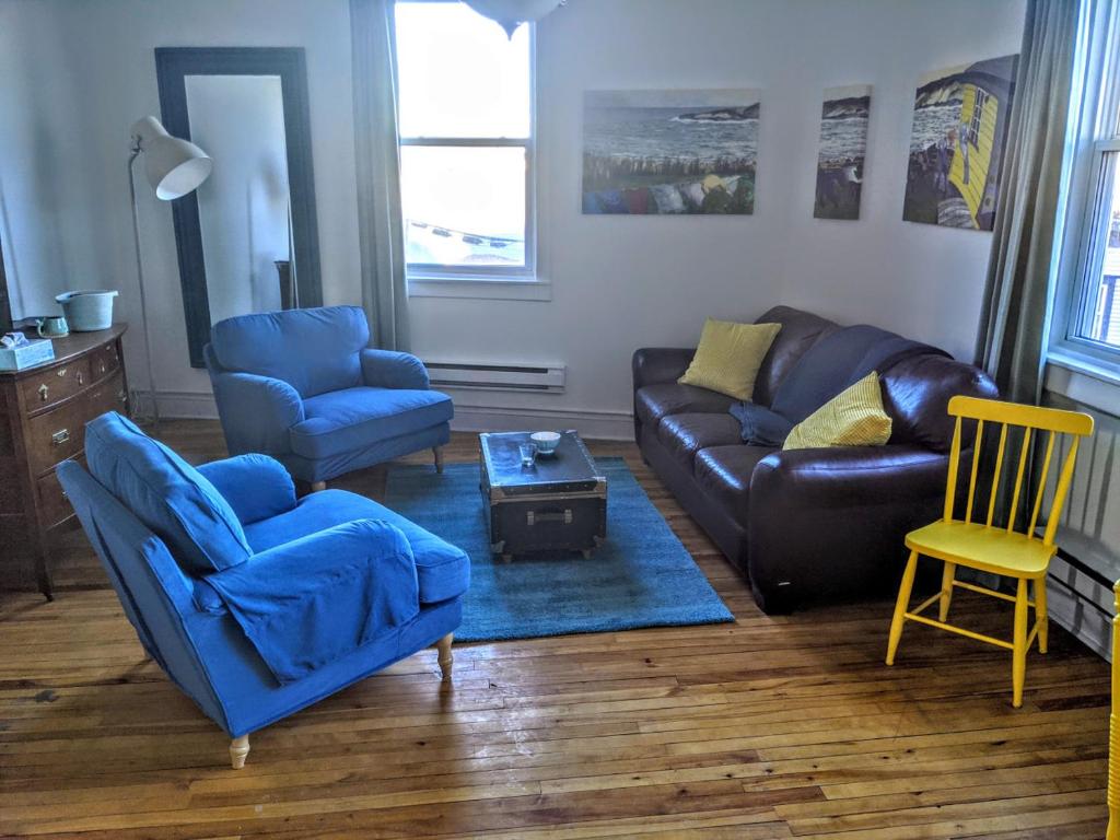 a living room with a leather couch and chairs at Downtown Apt 2 executive 21 Queens Road in St. John's