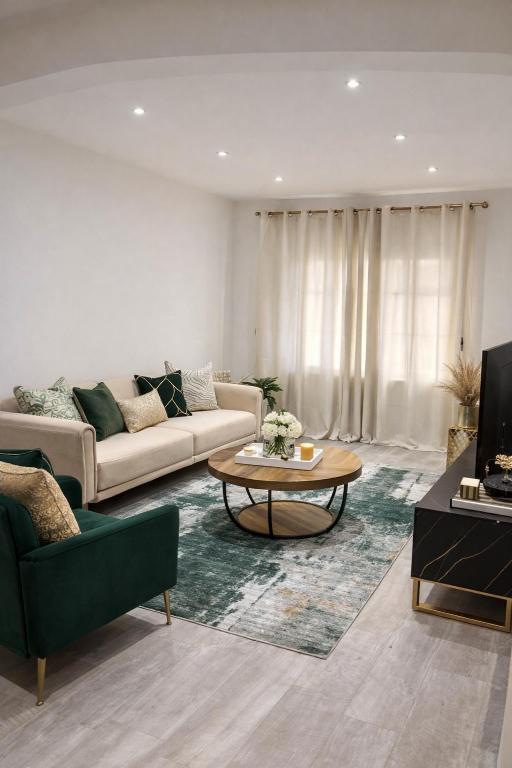 a living room with a couch and a table at Spacious 2 bedoom house in Wyken