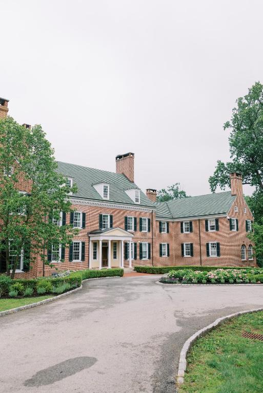 a large brick building with a driveway in front at Bohemia Manor Farm in Chesapeake City