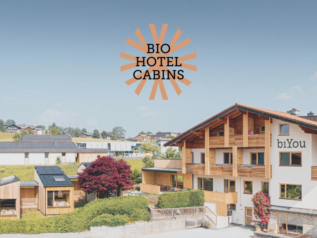 a building with a sign that reads bio hotel calitals at biYou Ecoquartier in den Bergen in Schladming