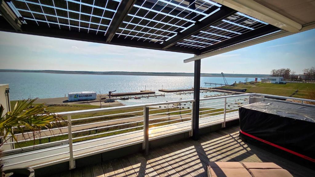 a balcony with a view of a body of water at Penthouse Seebrise in Großräschen