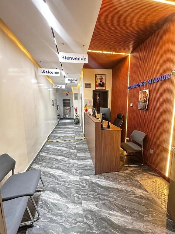 a hallway of a hospital with a reception desk and chairs at Résidence Madior C3 in Dakar