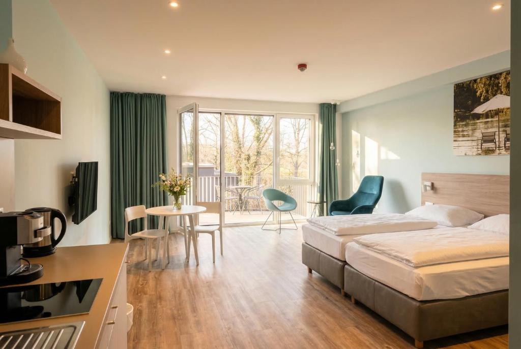 a hotel room with a bed and a table and chairs at Steverbett Hotel in Lüdinghausen