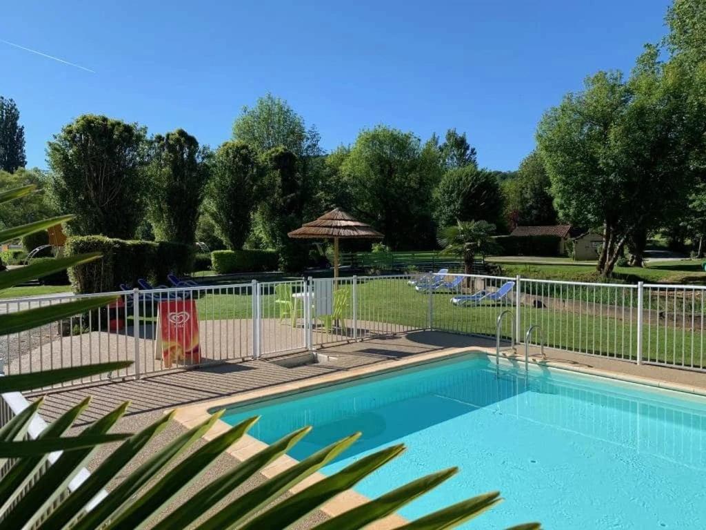 a swimming pool with a fence around it at Camping 3 étoiles - Piscine - ccbfhii in Bouzic
