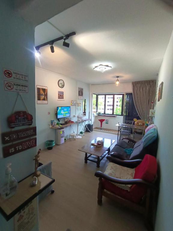 a living room with a couch and a table at Kluang Countryside Scenery NO LIFT SECOND FLOOR#NETFLIX#RETRO GAME in Kluang