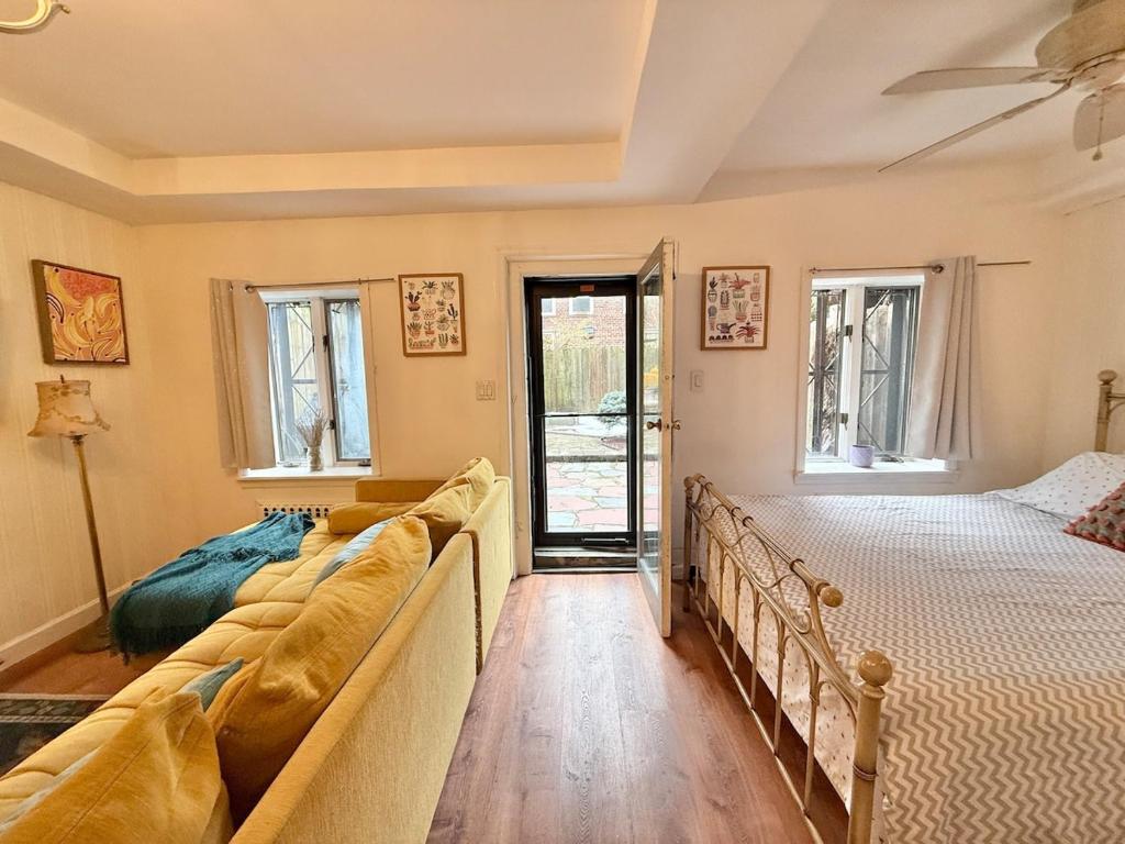 a bedroom with two beds and a couch at Cozy Manhattan View Suite in West New York