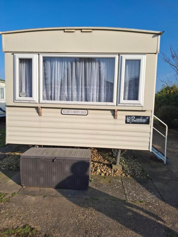 a house with a window on the side of it at Comforts caravan in Winthorpe
