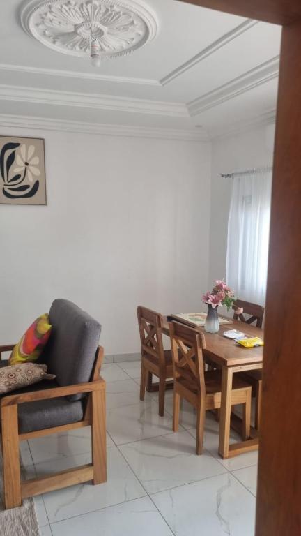 a living room with a dining room table and chairs at RESIDENCE Tanta in Douala