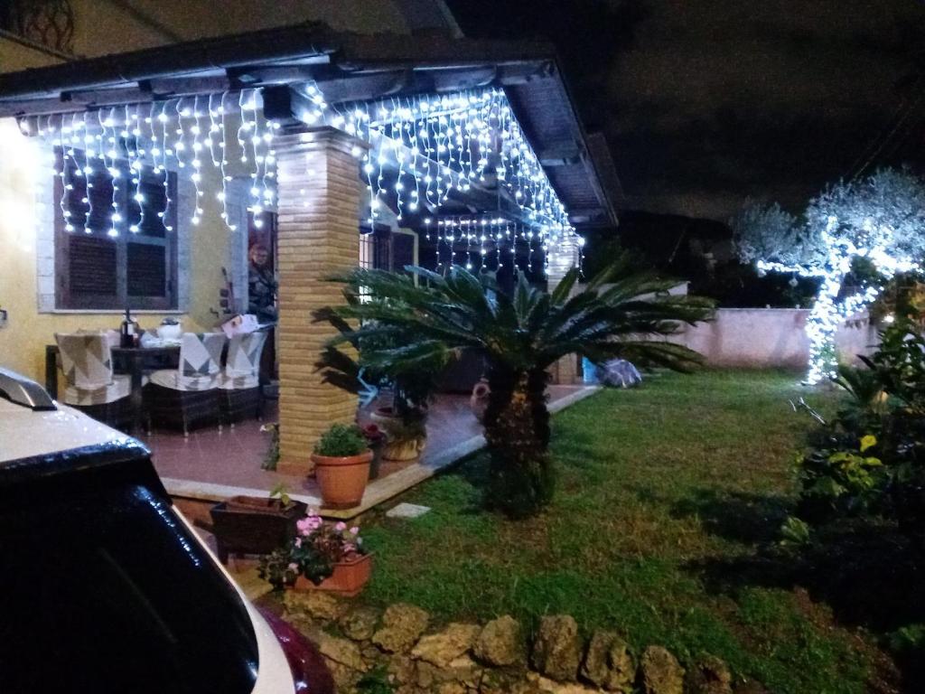 a house with christmas lights on the front yard at Aghi&Salsedine in Anzio