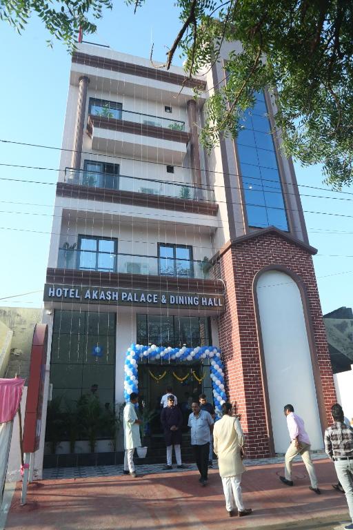 a group of people standing outside of a building at Hotel Akash Palace in Shāhpur