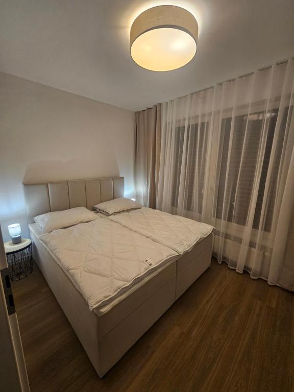 a bedroom with a large bed in a room at 365 apartmány AUPARK in Piešťany