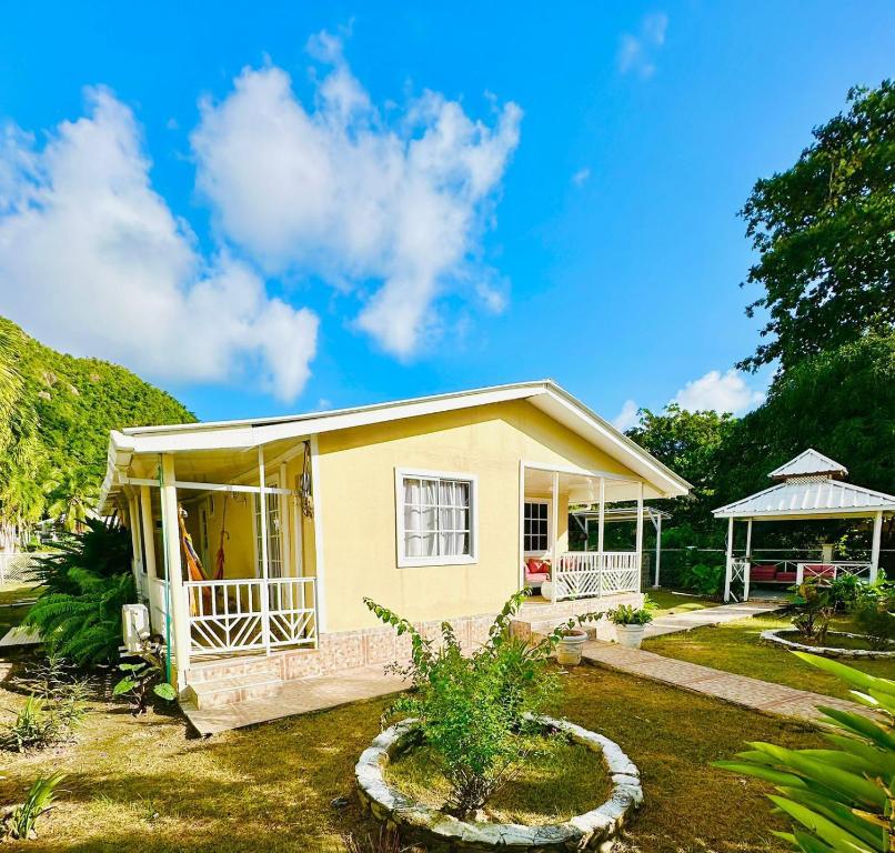 a small yellow house with a gazebo at Enchanted Paradise in Ayacucho