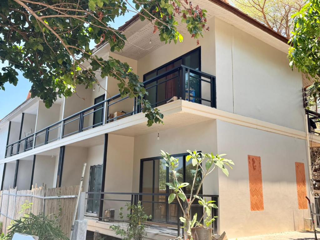 an exterior view of a house with black windows at Phi Phi Vista Nest Resort in Phi Phi Islands