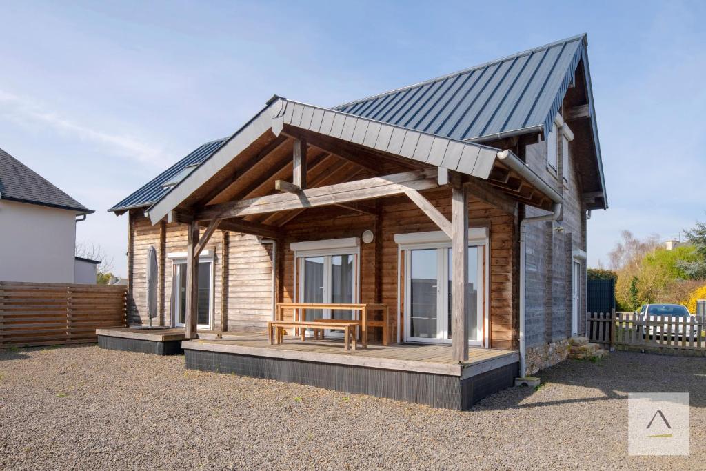 a small wooden cabin with a pitched roof at La Cabane à Hirel in Hirel
