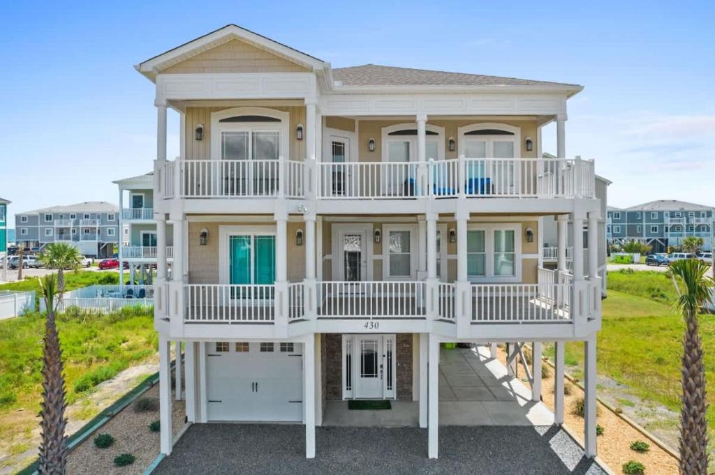 a large house with a wrap around balcony at East End Views in Ocean Isle Beach
