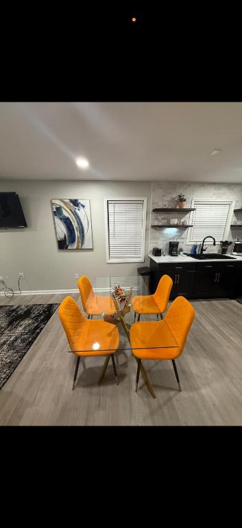 two orange chairs and a table in a living room at Uptown Modern Escape 4bd 2ba in Memphis