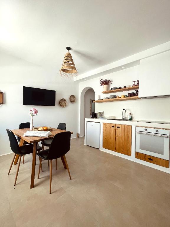 a kitchen and dining room with a table and chairs at Konstantza's Elegant Apartment in Naxos Chora