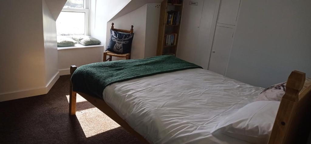 a small bed in a room with a window at ABC Bladnoch in Newton Stewart