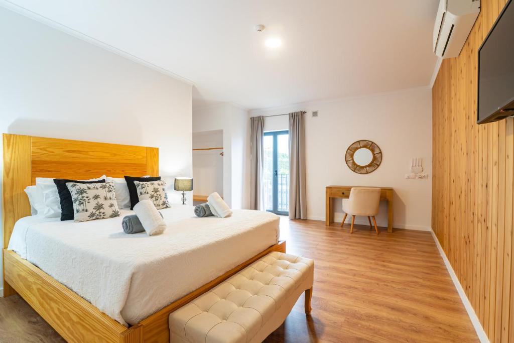 a large bedroom with a large bed and a desk at Vila Rosario in Ponta Delgada