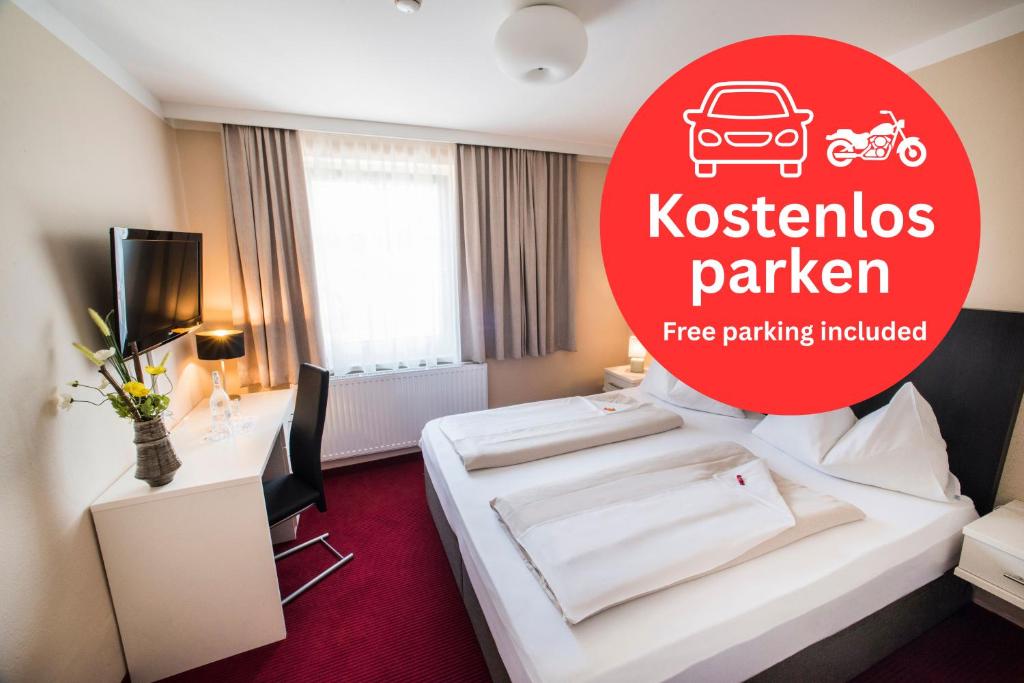 a hotel room with a white bed and a red sign at Stadthotel Kramer in Villach