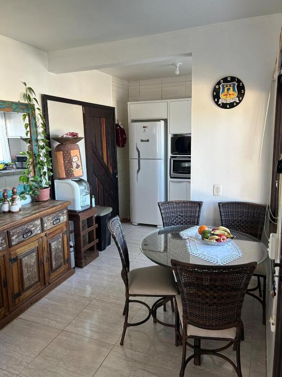 a kitchen with a table and chairs in a room at Pedra Branca Retreat in Garopaba