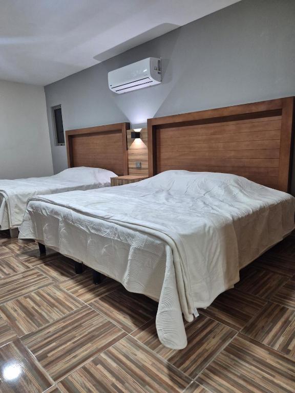 a bedroom with two beds and a fan at Hermosa suite anakoba 3 in La Concha