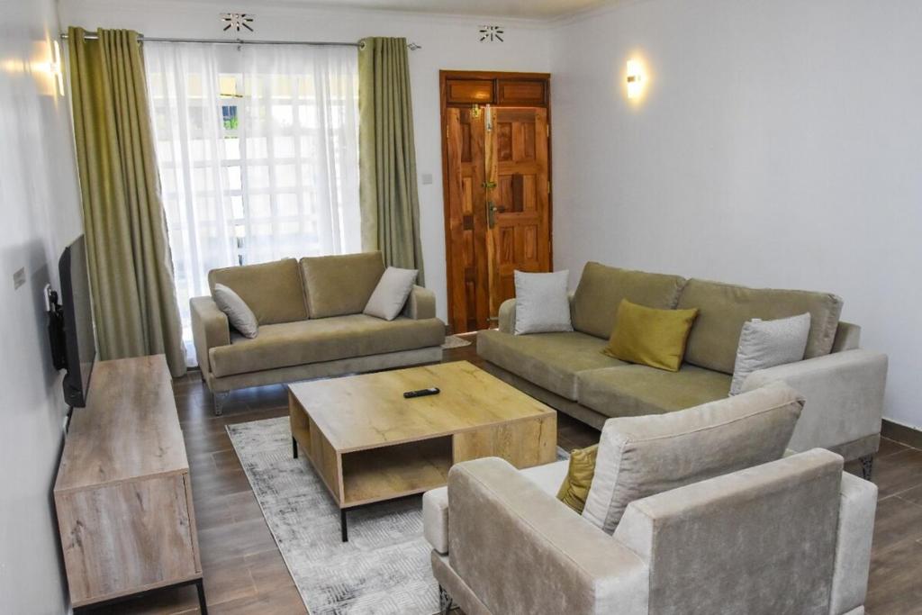 a living room with two couches and a coffee table at Pacificas place in Eldoret