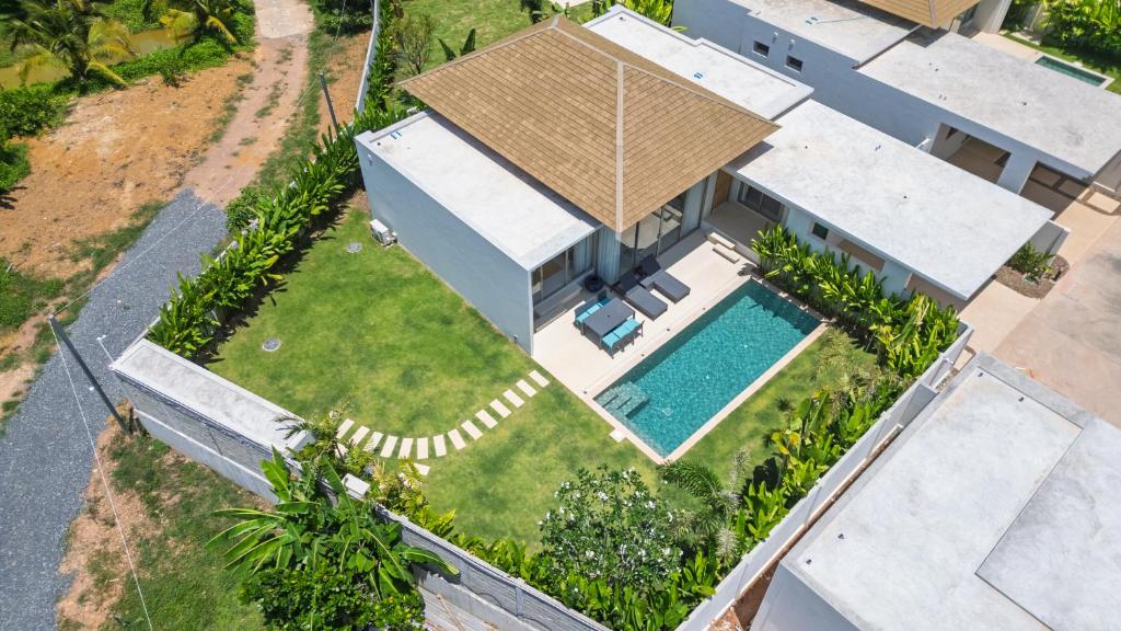 an aerial view of a house with a swimming pool at Trichada Essence in Ban Pak Lak