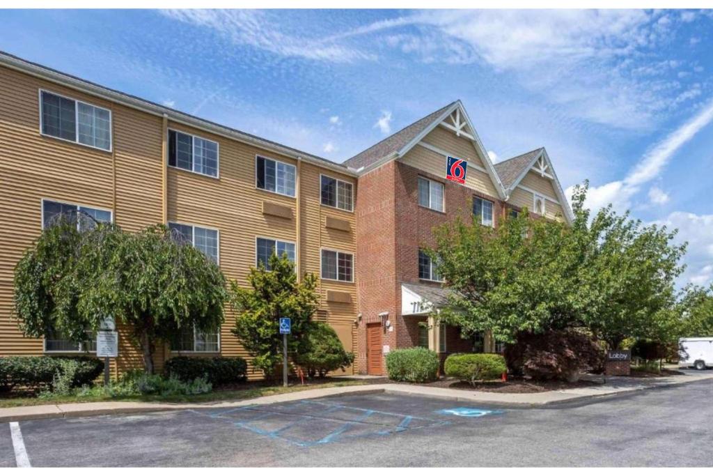 a building with a parking lot in front of it at Studio 6 Extended Stay Fishkill Route 9 NY in Fishkill