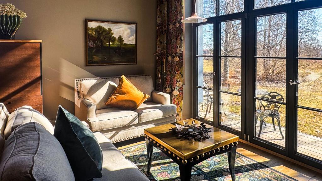 a living room with a couch and a table at Lossipark Guest Apartments - vis-à-vis Bishop's Castle in Haapsalu