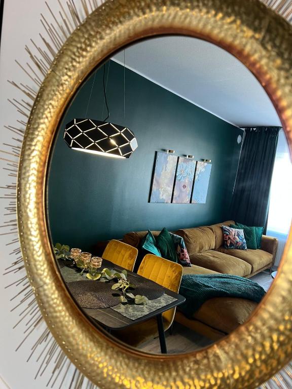 a mirror reflection of a living room with a couch at Andrelle Rental in Tõrvandi