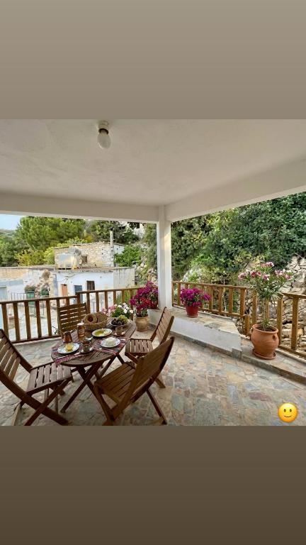 a patio with a table and chairs on a porch at Aski house - Authentic Cretan life by Hostinous in Askoí