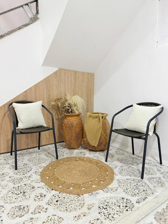 two chairs and a rug in a room at Loft 4 Bambú in Laureles Stadium in Medellín