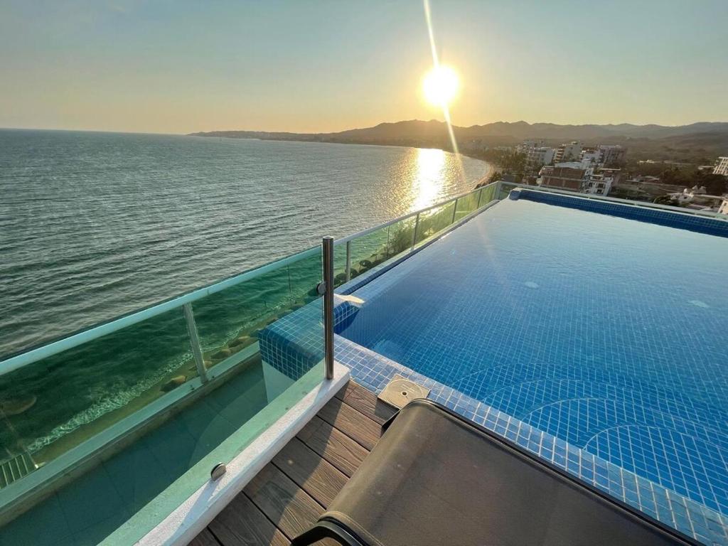 a swimming pool with a view of the water at Risco Centro de Bucerías beachfront with pool in Bucerías