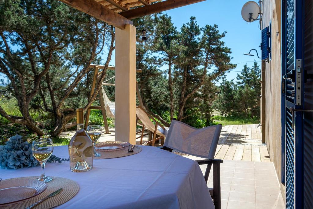a table with a blue table cloth and wine glasses at Casa Garrover - Calma entre Sabinas in Illes Balears
