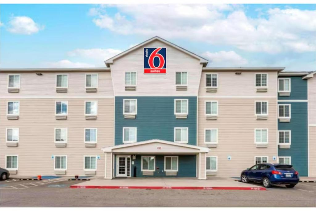 a large hotel with a car parked in a parking lot at Studio 6 Extended Stay El Paso East TX in El Paso