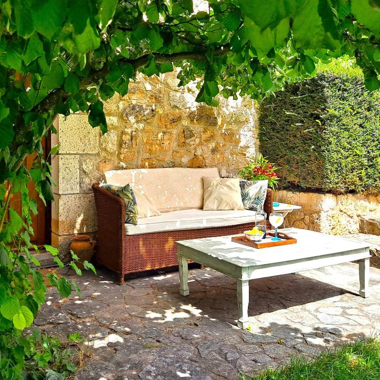 a couch and a coffee table on a patio at Molino De La Vega in Arcos