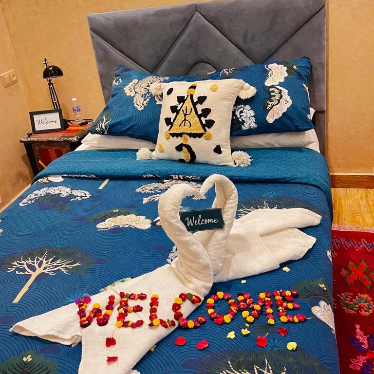 a bed with two swans made out of towels at Apartment 7 minutes walk from Menara Airport in Marrakesh
