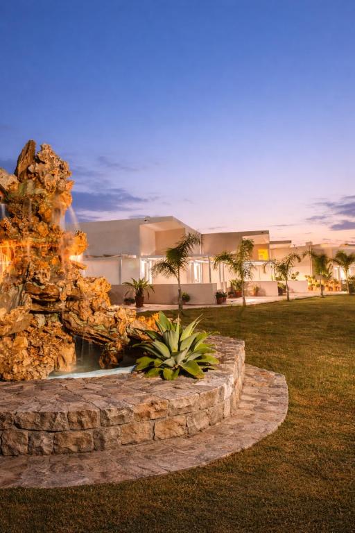 a water fountain in front of a house at Argiri Apartments & Suites in Georgioupolis
