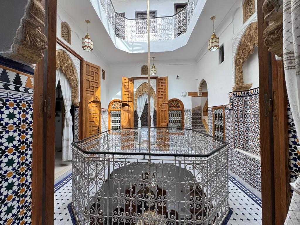 a room with a large glass table in a building at Riad AYA in Rabat