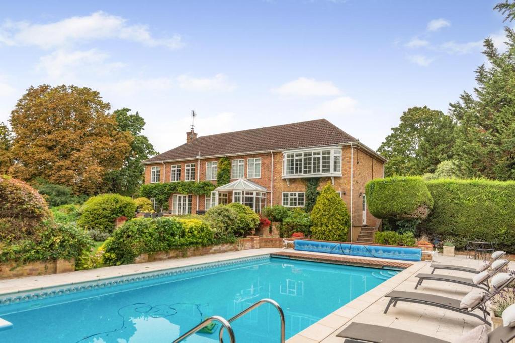 a home with a swimming pool in front of a house at 4 Bed in Bray oc-b32610 in Bray