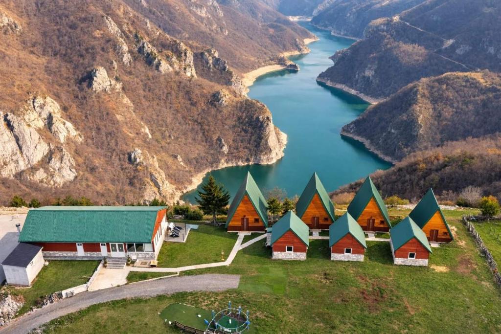 an aerial view of a house on a hill next to a river at Rural Resort Tron in Plužine