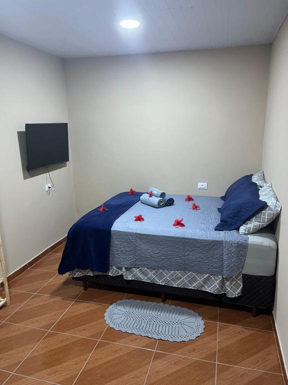 a bedroom with a bed with red flowers on it at Flat Yellowtuna in Fernando de Noronha