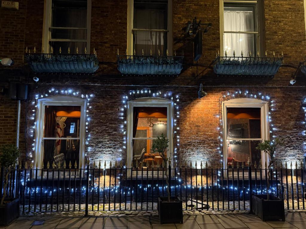 a brick house with lights on it at night at Durham Central Suites in Gilesgate